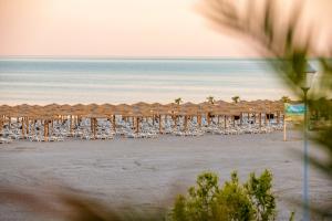 a group of chairs and umbrellas on a beach at Mera Maris in Cap Aurora