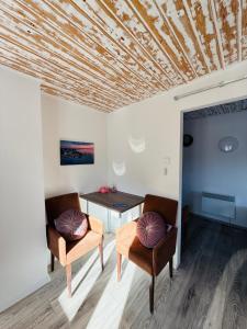 a dining room with a table and two chairs at Balcsitthon Apartmanok in Siófok +126 photos