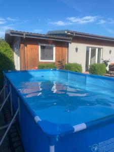 a large blue swimming pool in front of a house at AgroReset in Korlino