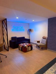 a living room with a couch and a bed in a room at Elegant 1BR Unit at Bryant Parklane, Capital Town near Malls and Tourist Destinations in Pampanga, Free Pool Access, Netflix, Prime Video in San Fernando