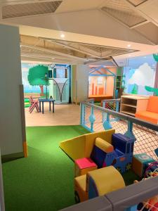 a childrens play room with colorful chairs and a playground at Elegant 1BR Unit at Bryant Parklane, Capital Town near Malls and Tourist Destinations in Pampanga, Free Pool Access, Netflix, Prime Video in San Fernando