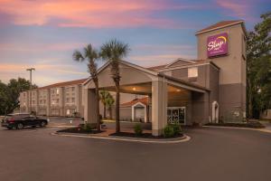 a hotel with a car parked in a parking lot at Sleep Inn Beaufort near MCAS in Beaufort