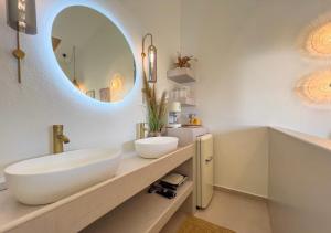 a bathroom with a white sink and a mirror at Villa Emilia Suites in Pachis +23 photos