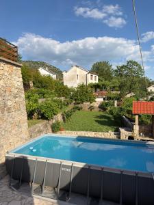 a swimming pool in a yard with a house at Casa di Kiara, Skadar Lake in Dodoši
