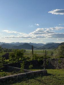a view of a field with mountains in the distance at Casa di Kiara, Skadar Lake in Dodoši