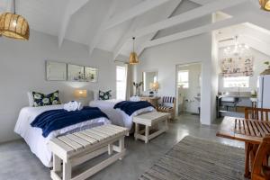 a bedroom with two beds and a dining room at At3Brides Self Catering in St. Helena Bay