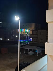 a street light in a parking lot at night at See you soon blue Beach in Marsa Matruh