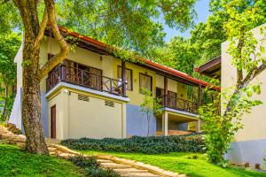 an exterior view of a house with trees at NatureSurf Villas - Private Garden Retreat at Hiriketiya Beach SPA, Surf & Relaxation in Dickwella