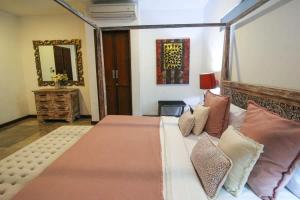 a bedroom with a large bed with pillows at Villa Yasmin in Seminyak +48 photos