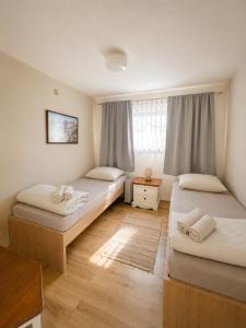 a bedroom with two beds and a window at Ubytování ve vinici in Hustopeče