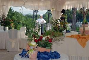 a chef standing at a table in a marquee with flowers at Hotel Collina di San Sisto in San Sisto