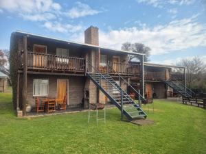 a house with a staircase on the side of it at Chargo River Lodge in Colesberg
