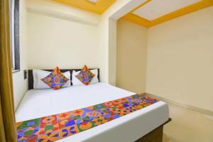a bedroom with a bed with a colorful comforter at FabHotel Silver Star in Pune