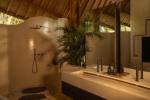 a bathroom with a sink and a mirror at Kaymana in Uluwatu +141 photos