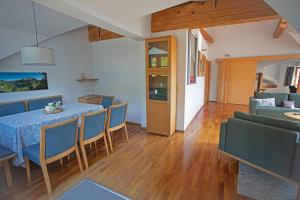 a dining room and living room with a table and chairs at Ferienwohnung Marienhof in Bad Aussee