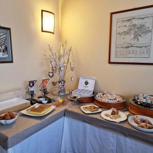 a buffet with different types of food on a table at Hotel Collina di San Sisto in San Sisto