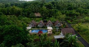 an aerial view of a house in a forest at Maskot Penida Cottage in Nusa Penida