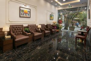 a waiting room with brown leather chairs and a waiting room at Bastra Classy Hotel in Hanoi