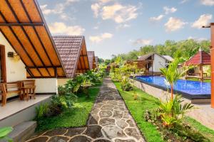 an image of a resort with a swimming pool at Maskot Penida Cottage in Nusa Penida
