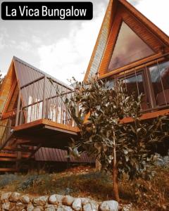 a house on a hill with a tree at La Vica Bungalow in Rize
