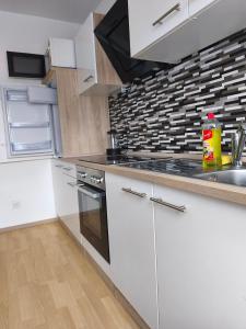a kitchen with white cabinets and a stove top oven at Monteurunterkunft nahe Münster in Drensteinfurt
