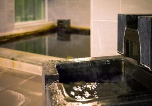 a kitchen with a sink with food in it at Super Hotel Kushiro-Ekimae in Kushiro