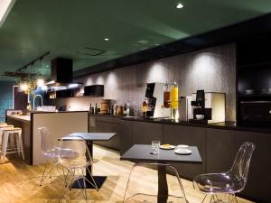 a kitchen with chairs and a table and a counter at Hotel Noir Blanc in Shizuoka