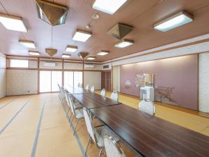 a large conference room with a long table and chairs at Subaruyado Yoshino in Tokushima