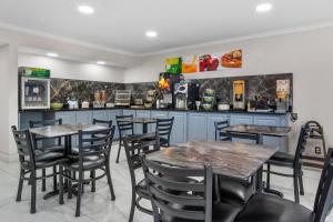 a restaurant with tables and chairs and a counter at Quality Inn Cedartown in Cedartown