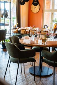 a dining room with wooden tables and chairs at Kruller - Hotel B&B in Otterlo +38 photos