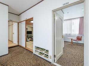 a room with a door to a room with wine bottles at Subaruyado Yoshino in Tokushima
