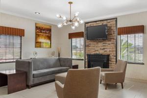 a living room with a couch and a television at Quality Inn & Suites Beaumont in Beaumont