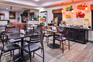 a restaurant with tables and chairs and a counter at Quality Inn & Suites Beaumont in Beaumont