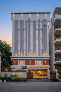 a large white building with a clock on it at 23 Urban Square in Hyderabad