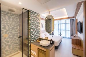 a bathroom with a bed and a sink and a mirror at Hotel Faranda Rias Altas, Ascend Hotel Collection in Oleiros +94 photos