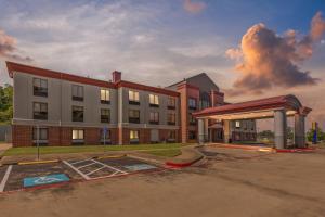 a building with a gas station in front of it at Comfort Inn & Suites Tyler North in Tyler