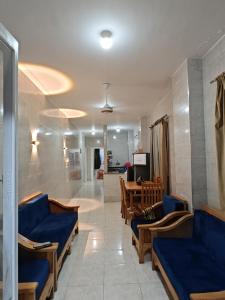 a waiting room with blue couches and a table at See you soon blue Beach in Marsa Matruh +40 photos