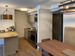 a kitchen and dining room with a table and a dining room at Bluegreen Vacations Streamside at Vail, an Ascend Collection Resort in Vail
