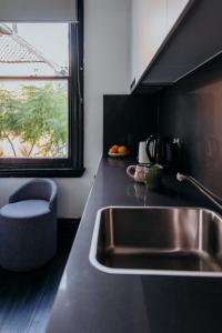 a kitchen with a sink and a window at Glebe Terraces in Sydney +38 photos