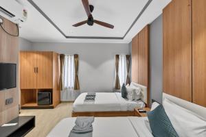 a bedroom with two beds and a ceiling fan at 23 Urban Square in Hyderabad +51 photos