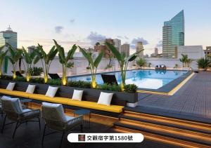 a rooftop patio with a pool on a building at The Howard Plaza Hotel Kaohsiung in Kaohsiung