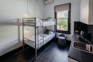 a kitchen with two bunk beds in a room at Glebe Terraces in Sydney