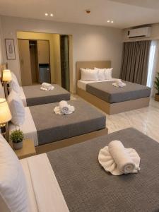 two beds in a hotel room with towels on them at Nile View Plaza Hotel in Cairo