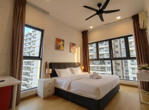 a bedroom with a bed with a ceiling fan at Amberside Coastal Breeze Oasis in Johor Bahru +82 photos