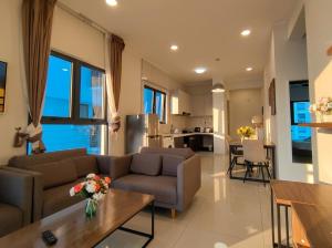 a living room with two couches and a table at Amberside Coastal Breeze Oasis in Johor Bahru