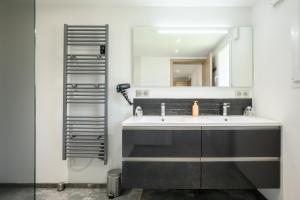 a bathroom with a sink and a mirror at Gîte Perce Neige, Spa, Sauna in Gerbépal +33 photos
