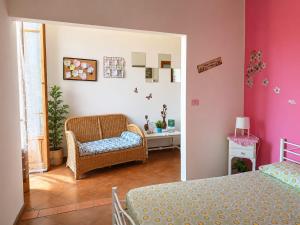 a room with two beds and a chair and a table at DiVino in Villa Viani