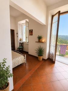 a room with a bed and a large window at DiVino in Villa Viani