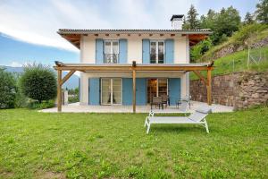 a house on a hill with a chair in the yard at Anika’s Home in Valfloriana
