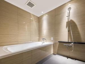 a large bathroom with a tub and a shower at Hotel Noir Blanc in Shizuoka